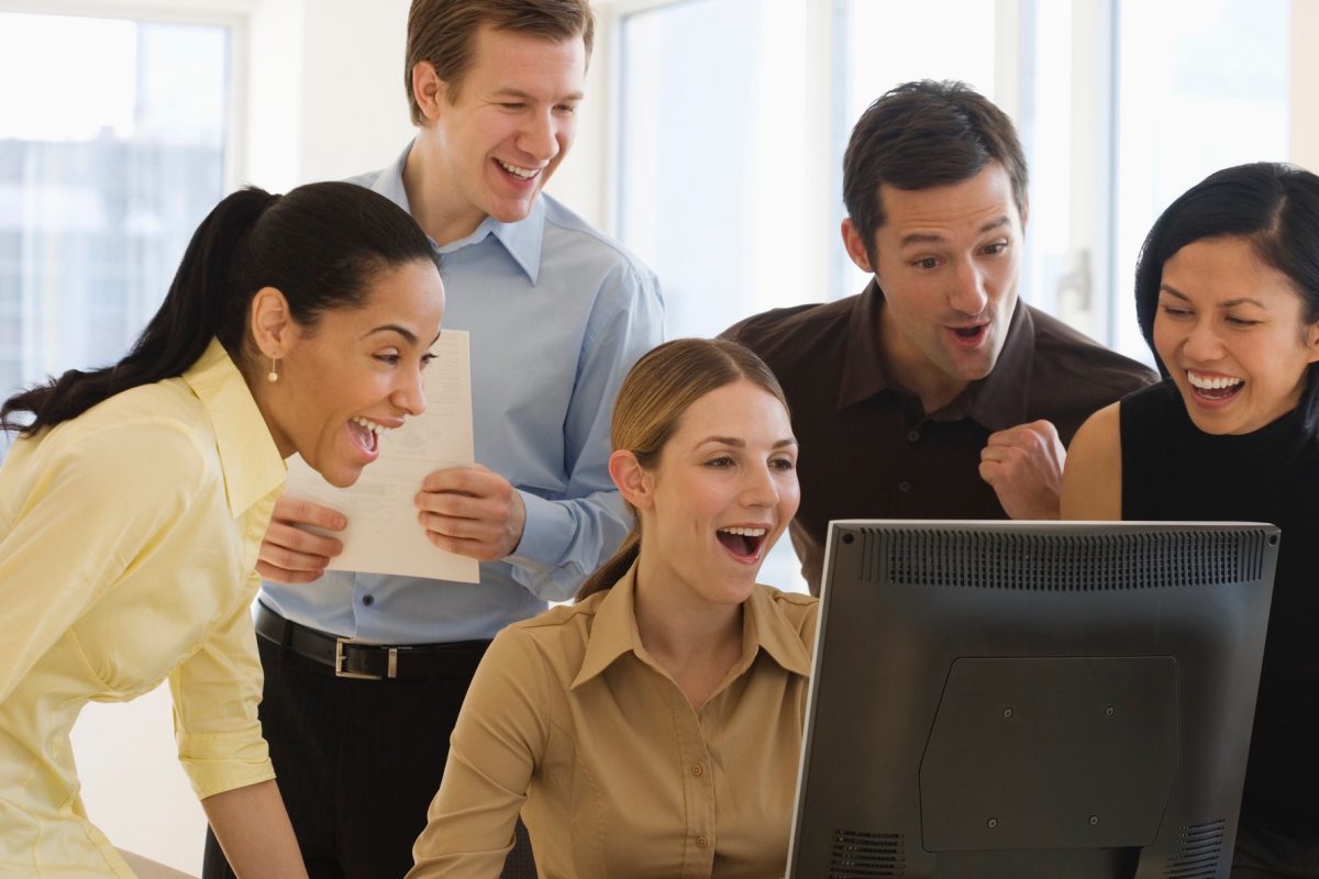 People happy around computer