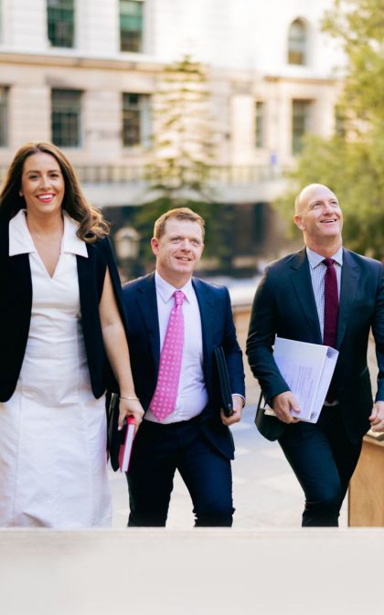 Melissa, Billy, and Shaun walking up court steps