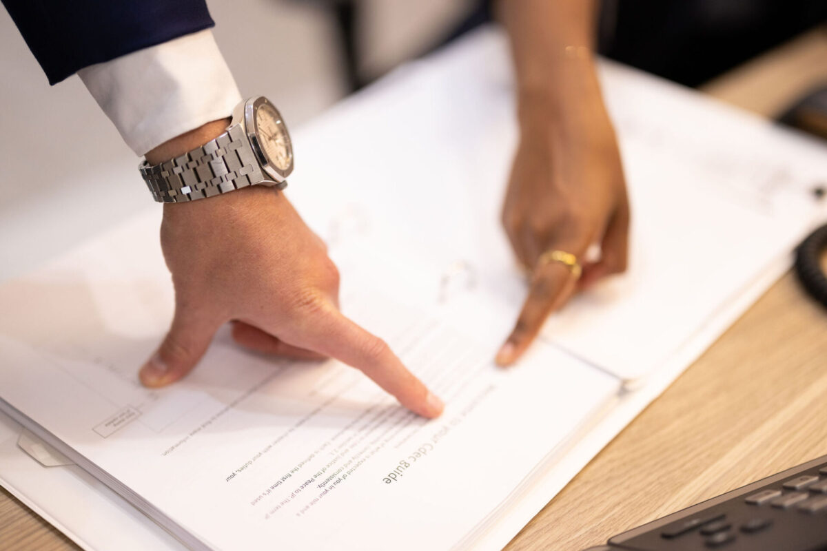 hands pointing to documents