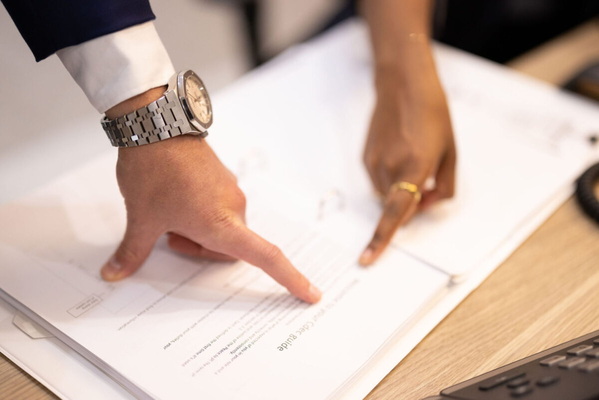 hands pointing to documents