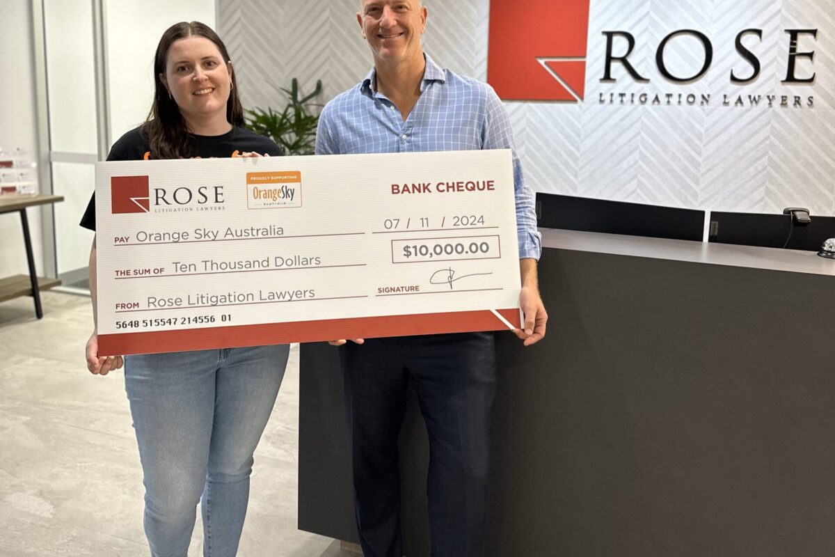 Shaun rose giving donation to Orange Sky